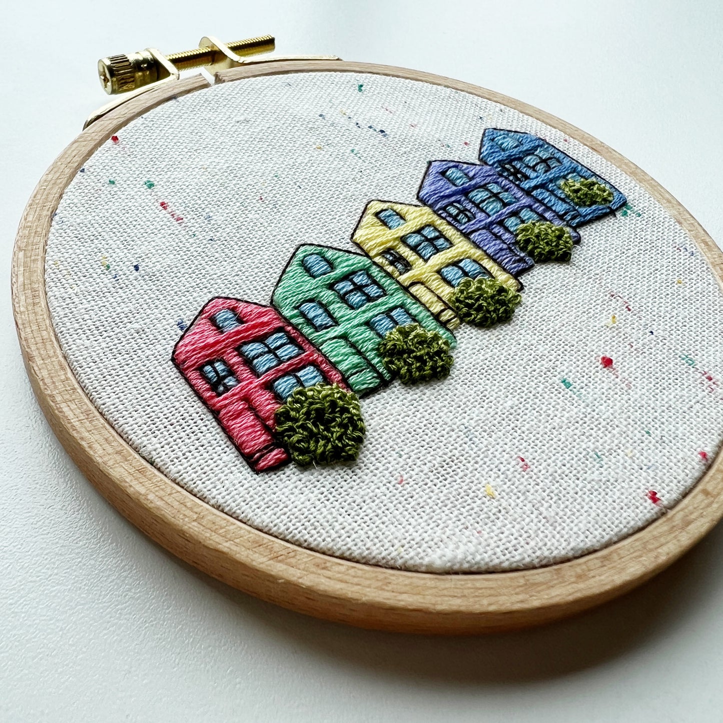 Painted Ladies Complete Embroidery Kit. 5 homes in red, green, yellow, purple and blue with shrubs in front. Reminiscent of San Francisco's Victorian homes on Steiner Street.