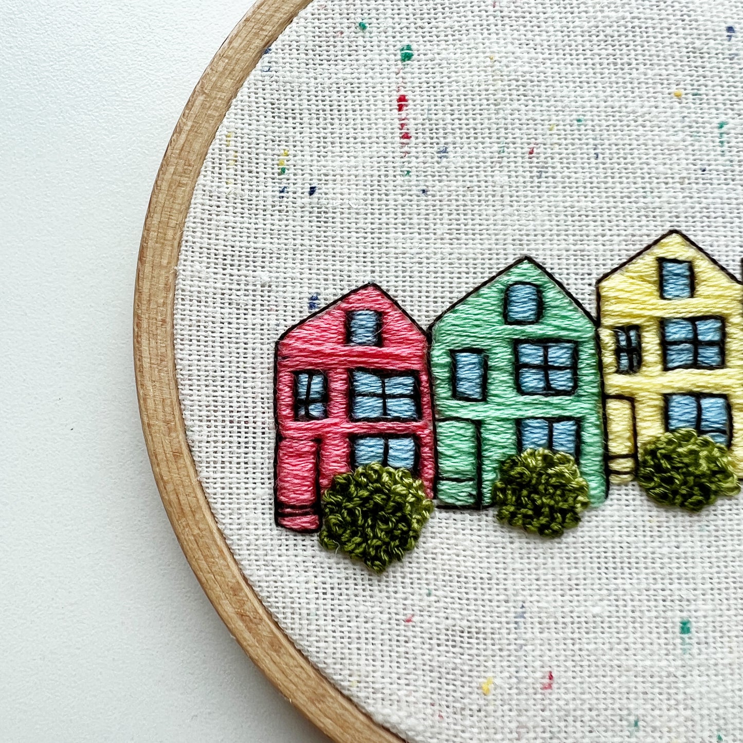 Close up of Rosanna Diggs Embroidery Kit Painted Ladies. Stitch detail defines windows and shrubs.