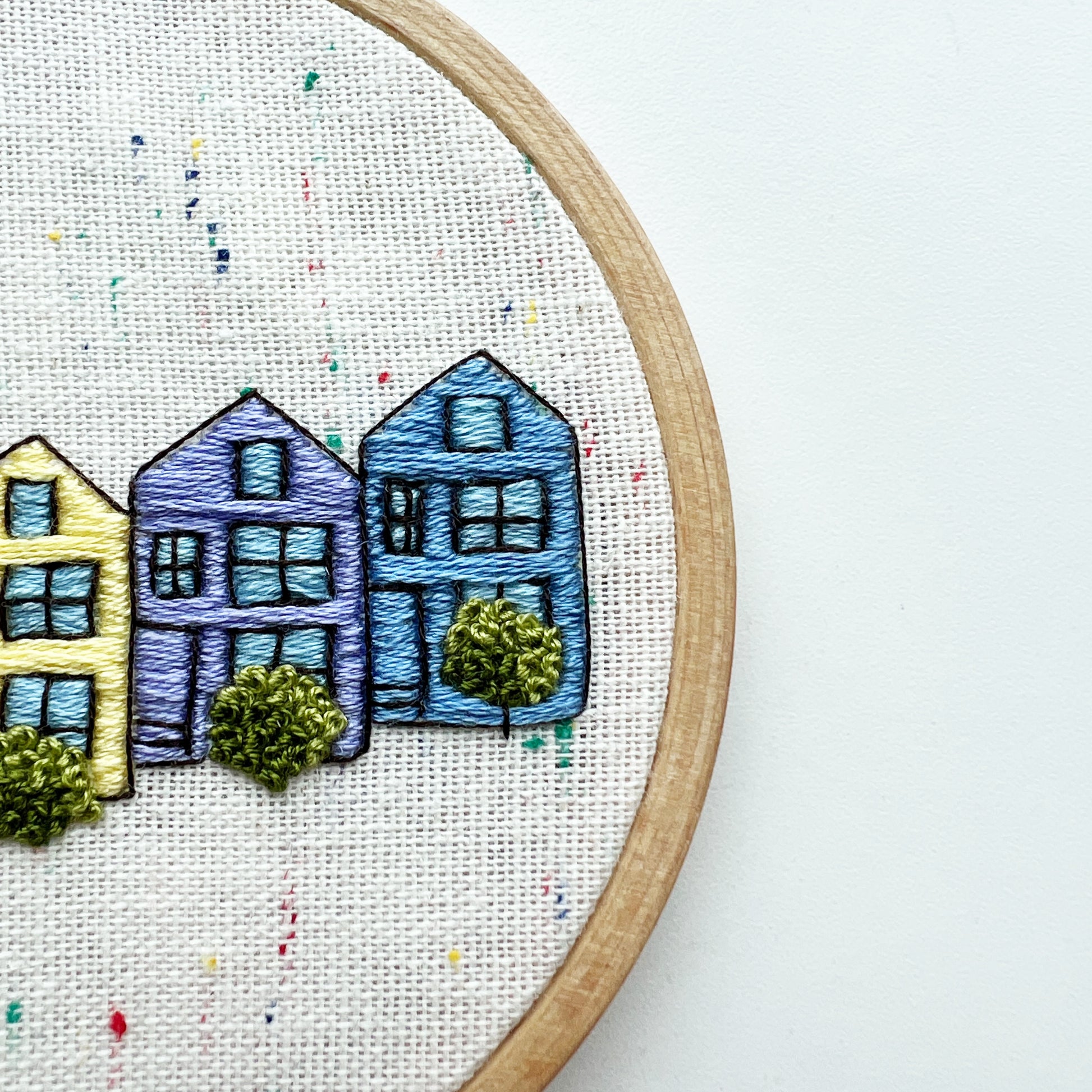 Close up of Rosanna Diggs Embroidery Kit Painted Ladies.  Stitch detail defines windows and shrubs.