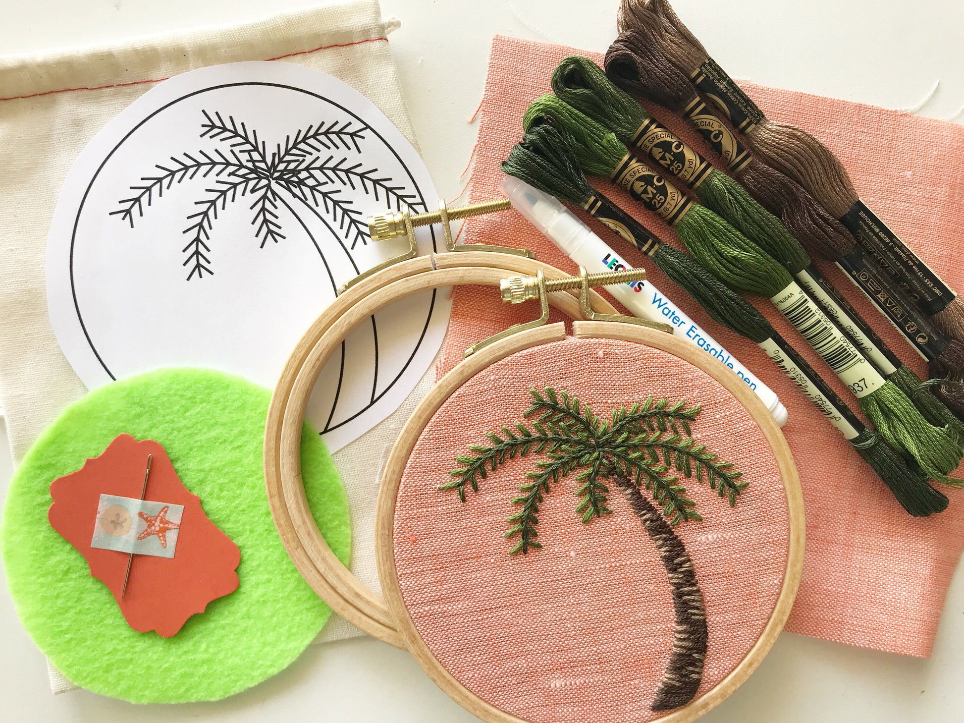 You will need: 4 inch wooden hoop, 6 inch square linen fabric, water soluble pen, 6 strand embroidery floss, needle, felt for backing, pattern, step-by-step instructions