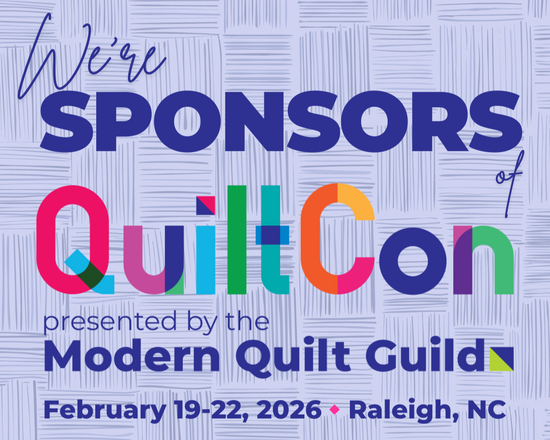 Promotional graphic for QuiltCon, featuring colorful text on a textured blue background.