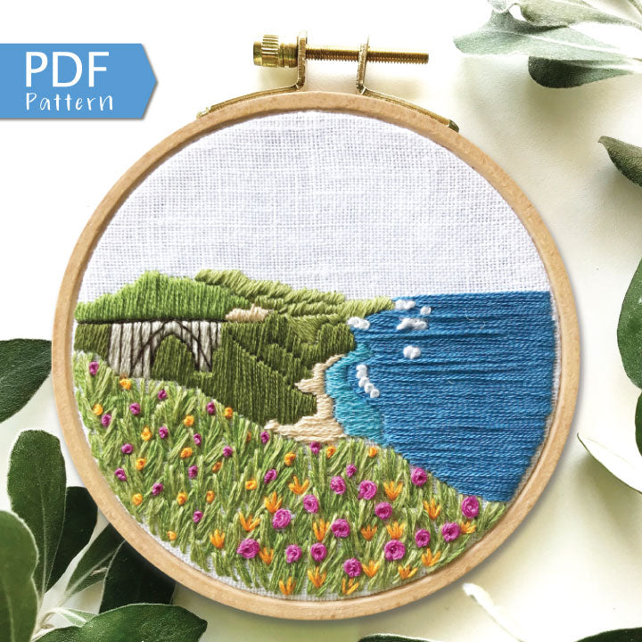 Big Sur California Hand Embroidery PDF. 13 page booklet gives easy to follow directions to complete this oceanside Modern Embroidery. Flowers in the foreground with HWY 101 Big Sur Bridge in the background. White waves crashing on beach.