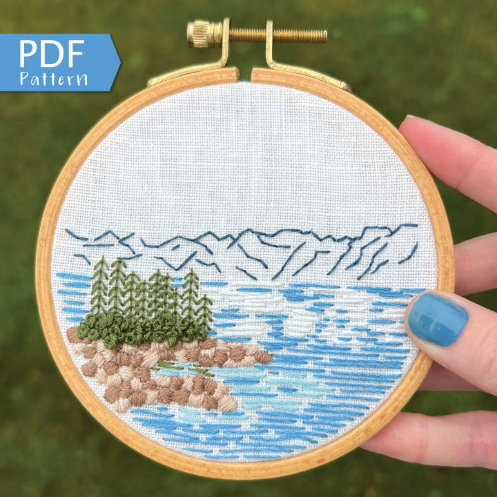 Lake Tahoe is a great pattern to DIY your own modern embroidery hoop art. This 12 page pdf details everything you need to know to stitch this beautiful embroidery.  Mountains in the background with trees, rocks and lake in front.