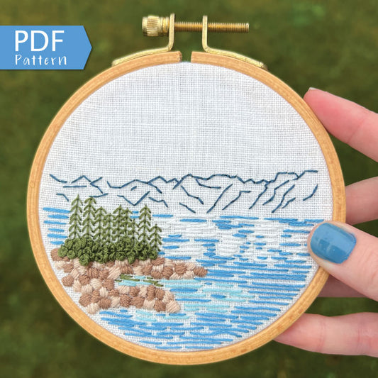 Lake Tahoe is a great pattern to DIY your own modern embroidery hoop art. This 12 page pdf details everything you need to know to stitch this beautiful embroidery.  Mountains in the background with trees, rocks and lake in front.