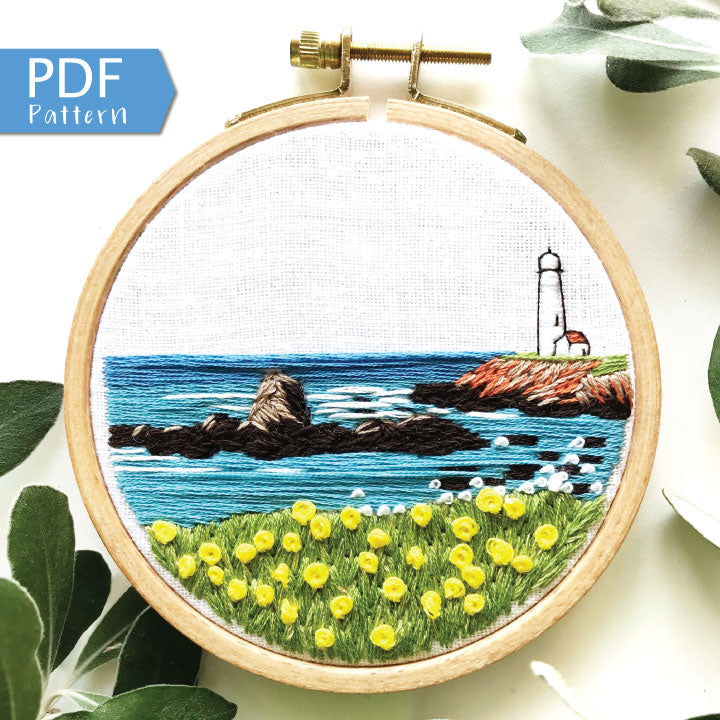 Lighthouse by the Bay PDF. Download includes easy to follow directions.  Hand Embroidery has lighthouse on the right hand side on cliff with rocks and ocean to the horizon.  Grass and flowers fill the foreground.