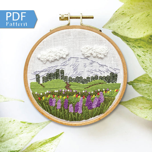 Mount Rainier Embroidery PDF.  Includes pattern for image transfer and 14 page booklet of easy to follow directions to complete.  Image has Mt Rainier in back with lupine and other small flowers in the foreground.