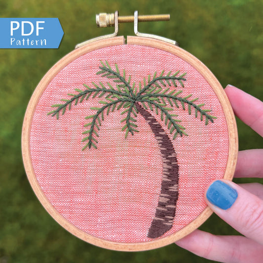 Palm Tree Hand Embroidery PDF.  Detailed colorwork highlights the bark of a palm tree with multicolored palm fronds.