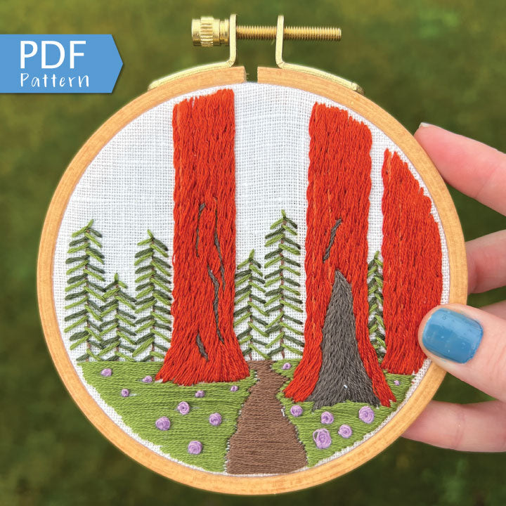Sequoia Grove PDF. Three tall Sequoias rise from the base of the embroidery with a small trail between them. PDF includes pattern for image transfer and 11 page booklet with easy to follow directions.
