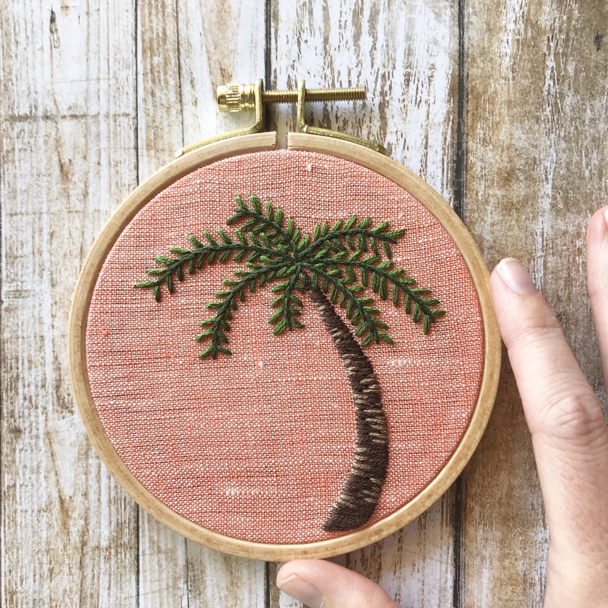 Palm Tree Hand Embroidery PDF.  Detailed colorwork highlights the bark of a palm tree with multicolored palm fronds.