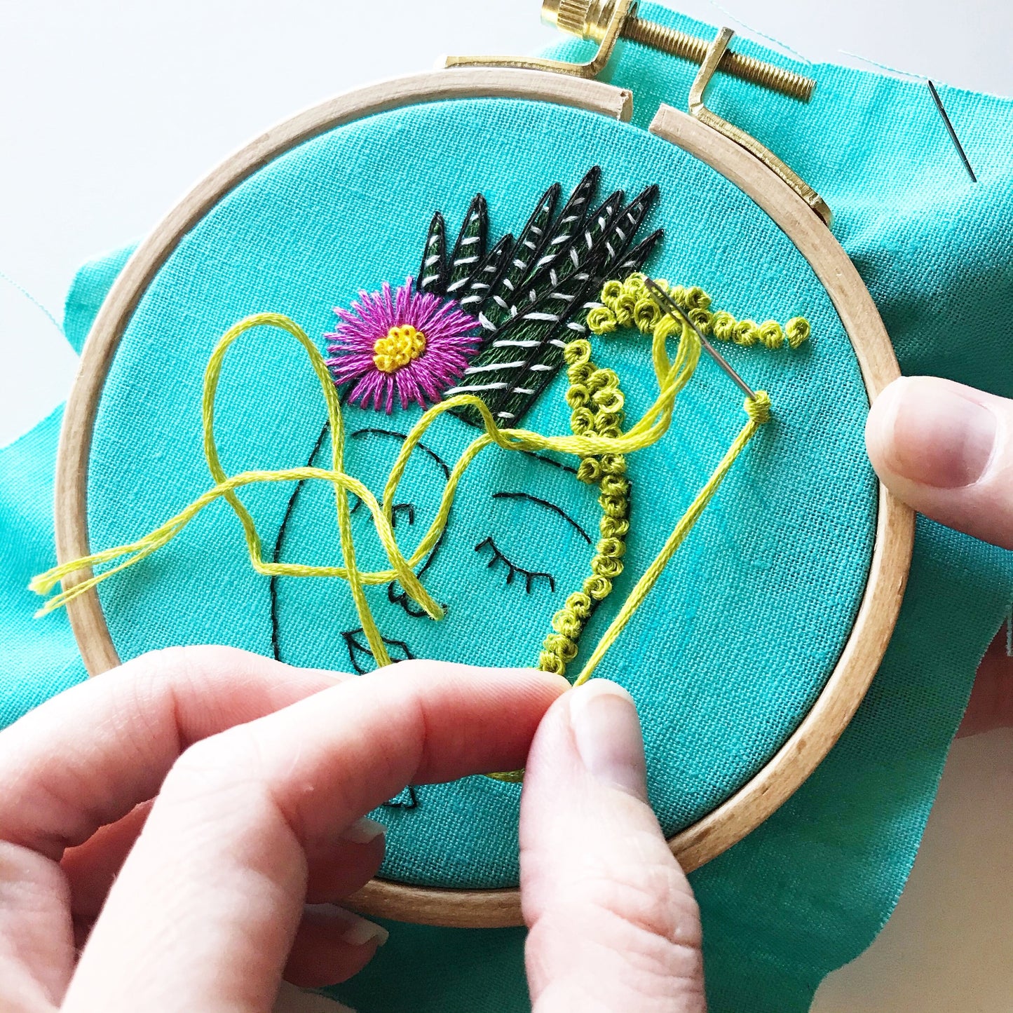 Zen Zoe Kit in progress. Needle showing knot in green over turquois linen.