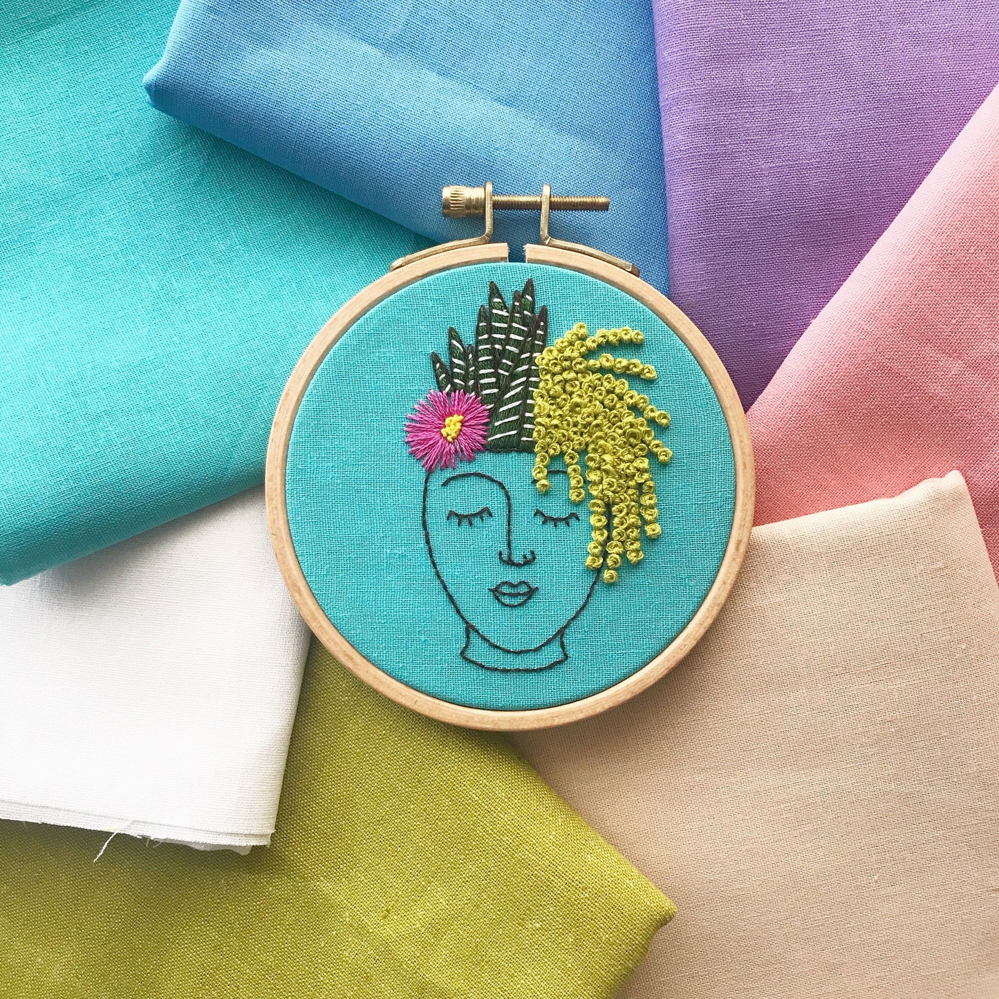 Zen Zoe PDF features a planter of a female face in black outline and has three different succulent plants cascading as her hair. PDF includes pattern for transfer and 11 page booklet with easy to follow directions.