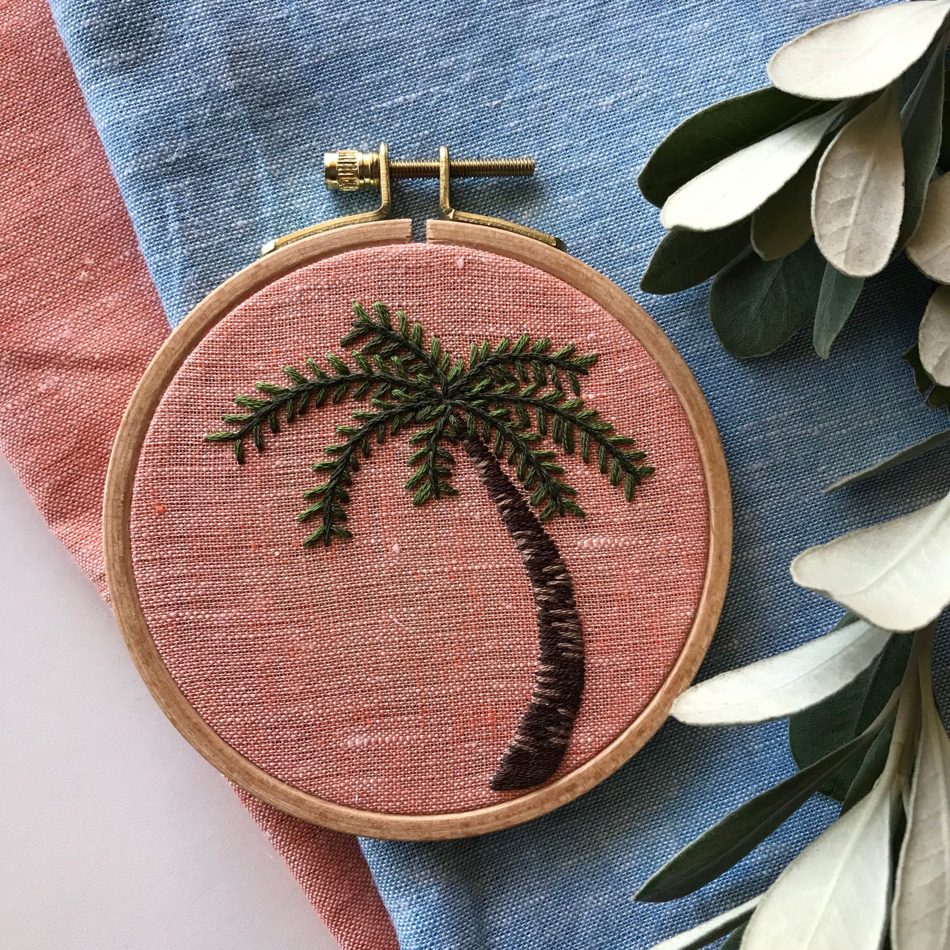 Palm Tree Hand Embroidery PDF.  Detailed colorwork highlights the bark of a palm tree with multicolored palm fronds.