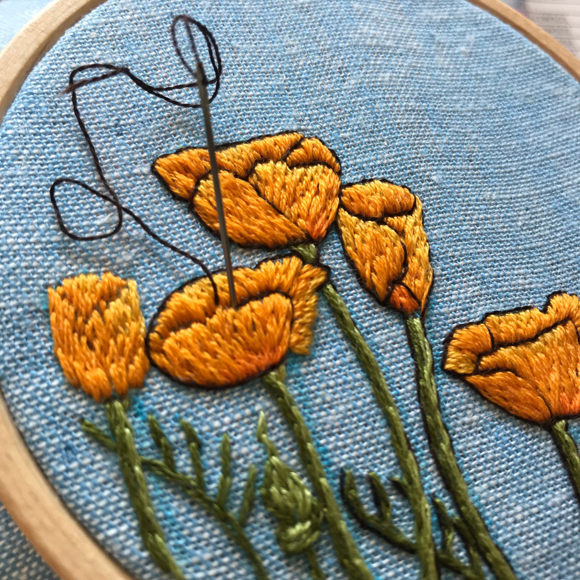 Peaceful Poppies kit in progress.  Highlight stitching added in black.