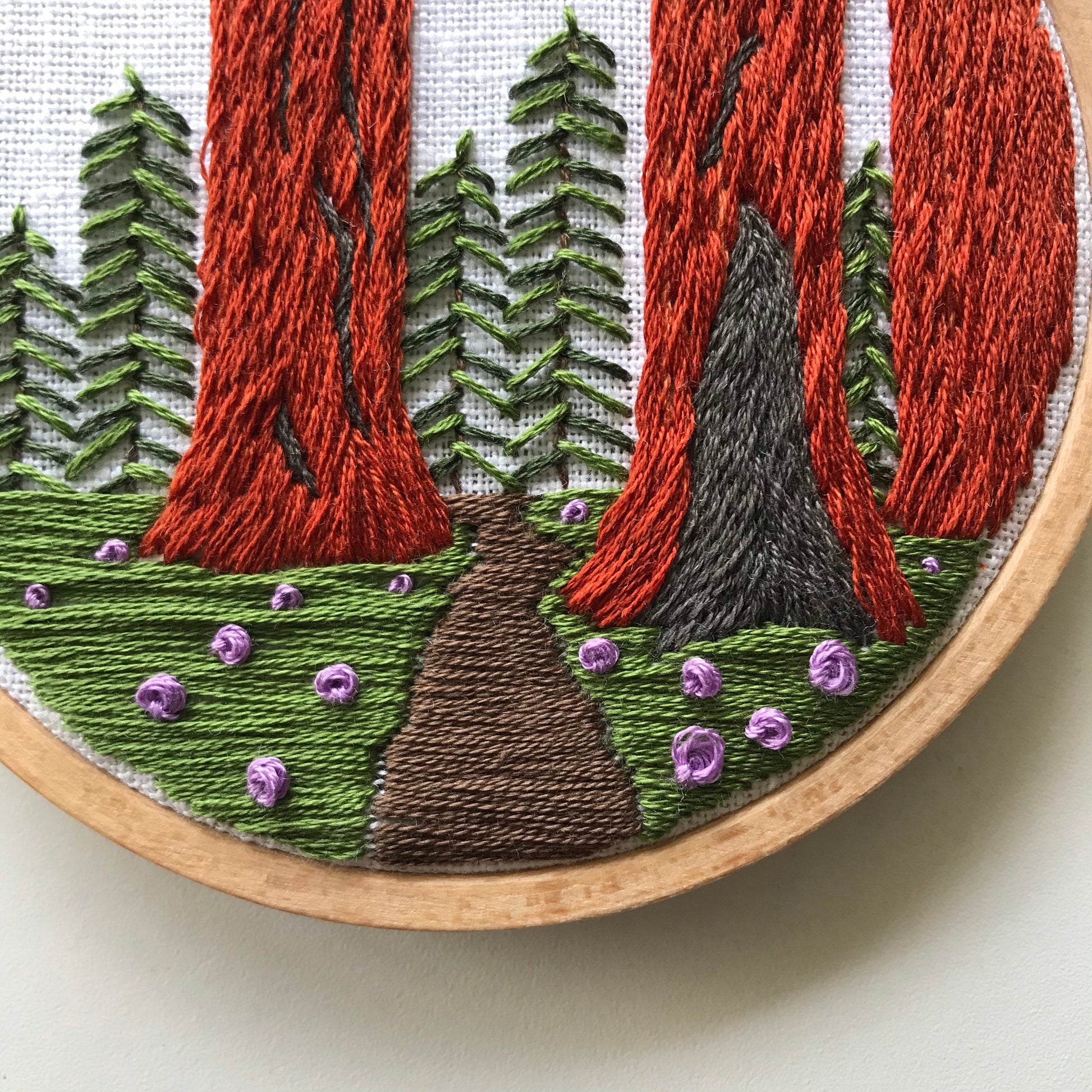 Sequoia Grove PDF. Three tall Sequoias rise from the base of the embroidery with a small trail between them. PDF includes pattern for image transfer and 11 page booklet with easy to follow directions.