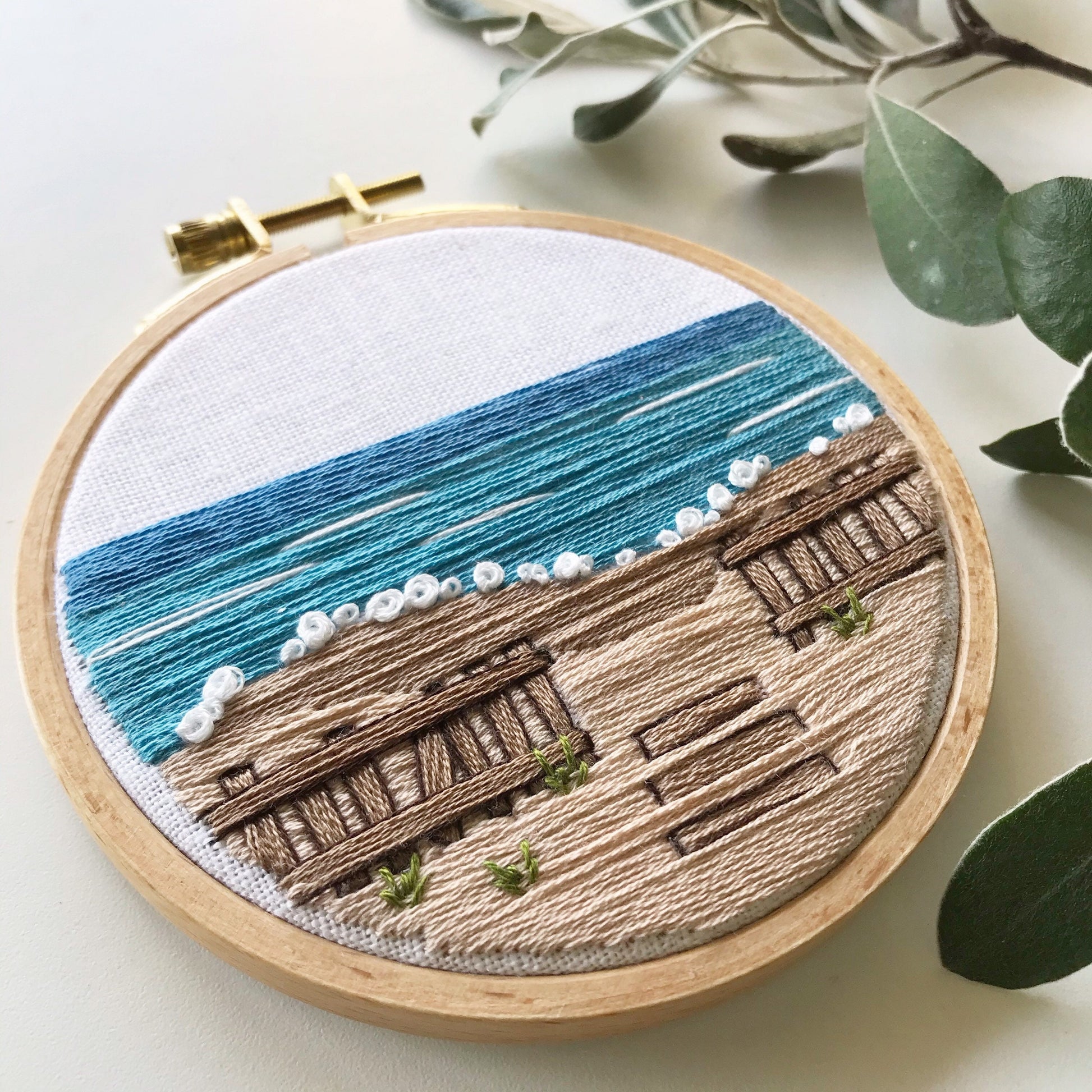 A Day at the Beach Modern Embroidery PDF contains a 12 page booklet of easy to follow directions so you can complete this beach scene with crashing waves on a sandy beach with a rustic fence.