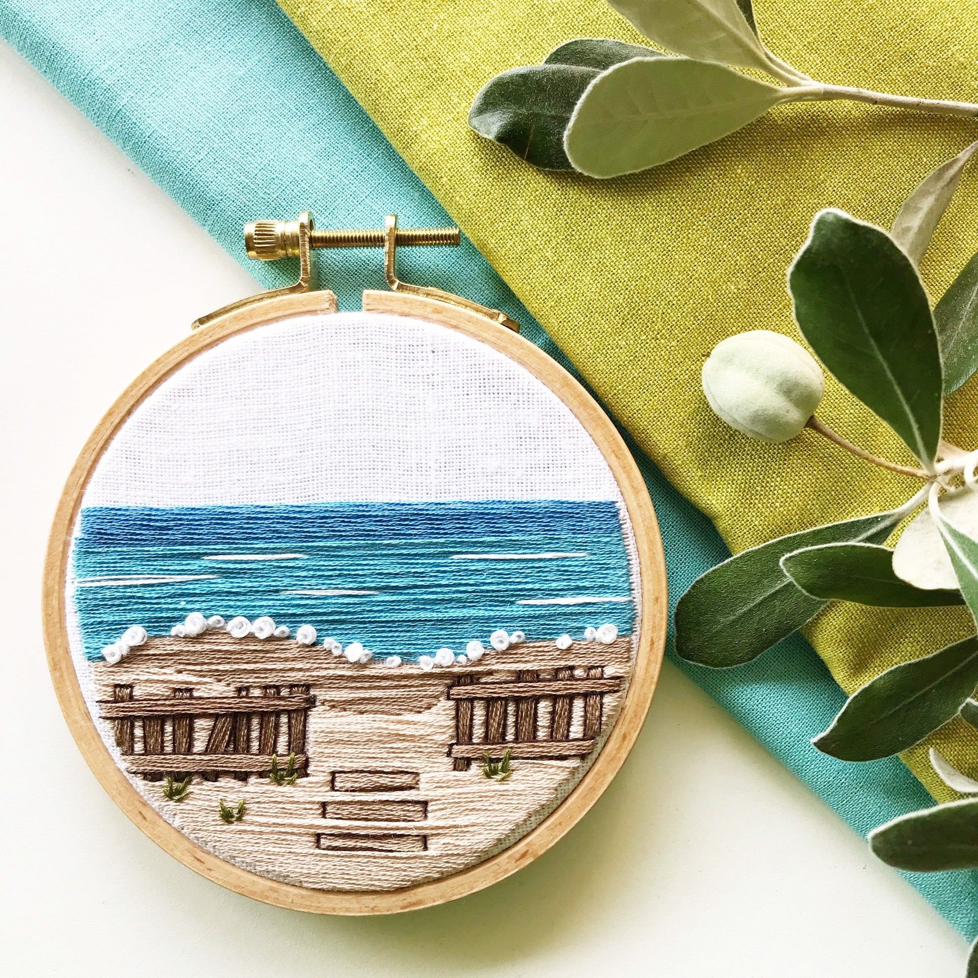 A Day at the Beach Modern Embroidery PDF contains a 12 page booklet of easy to follow directions so you can complete this beach scene with crashing waves on a sandy beach with a rustic fence.