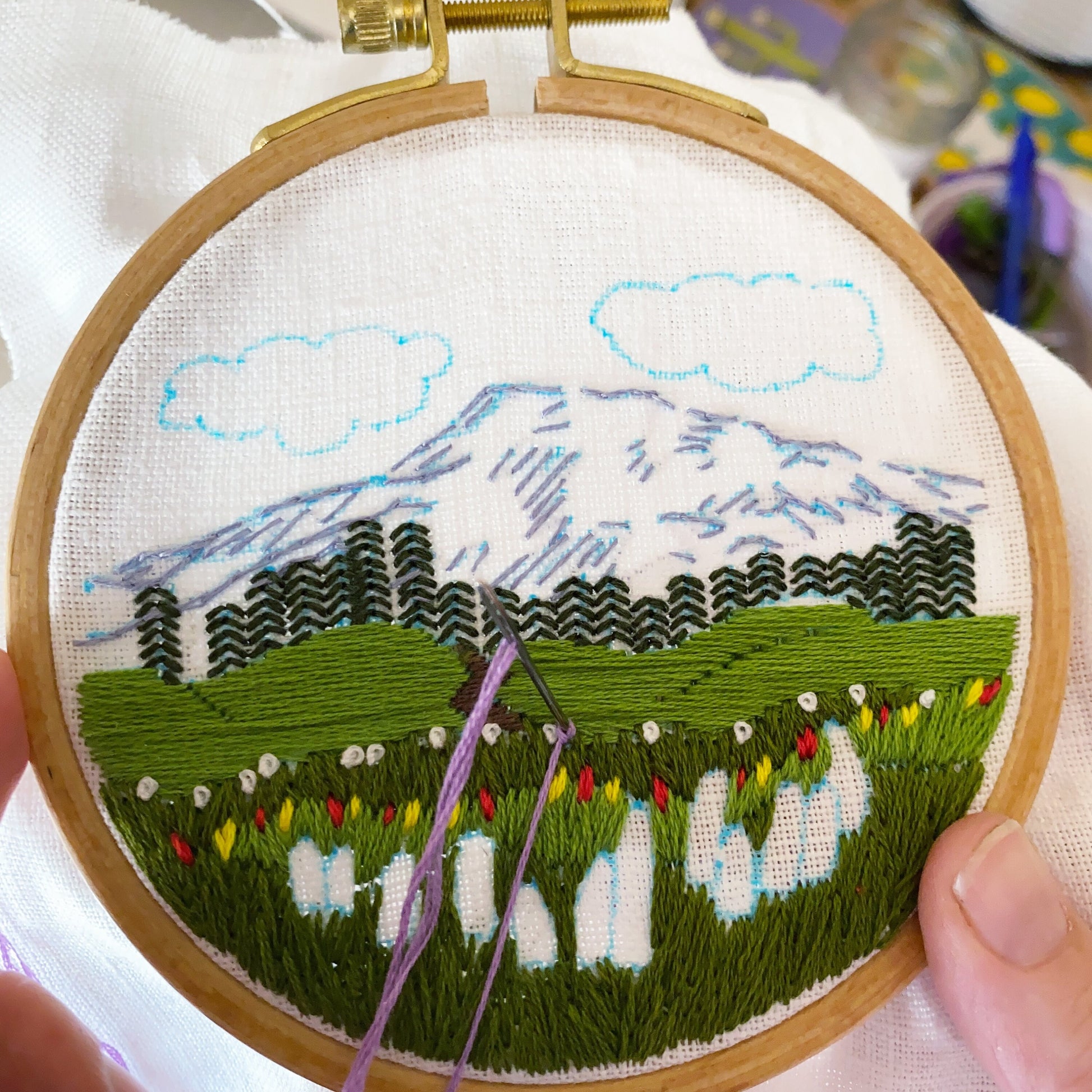 Mount Rainier Kit in progress.  Mountain is complete with background trees and foreground vegetation.  Purple knot in progress.