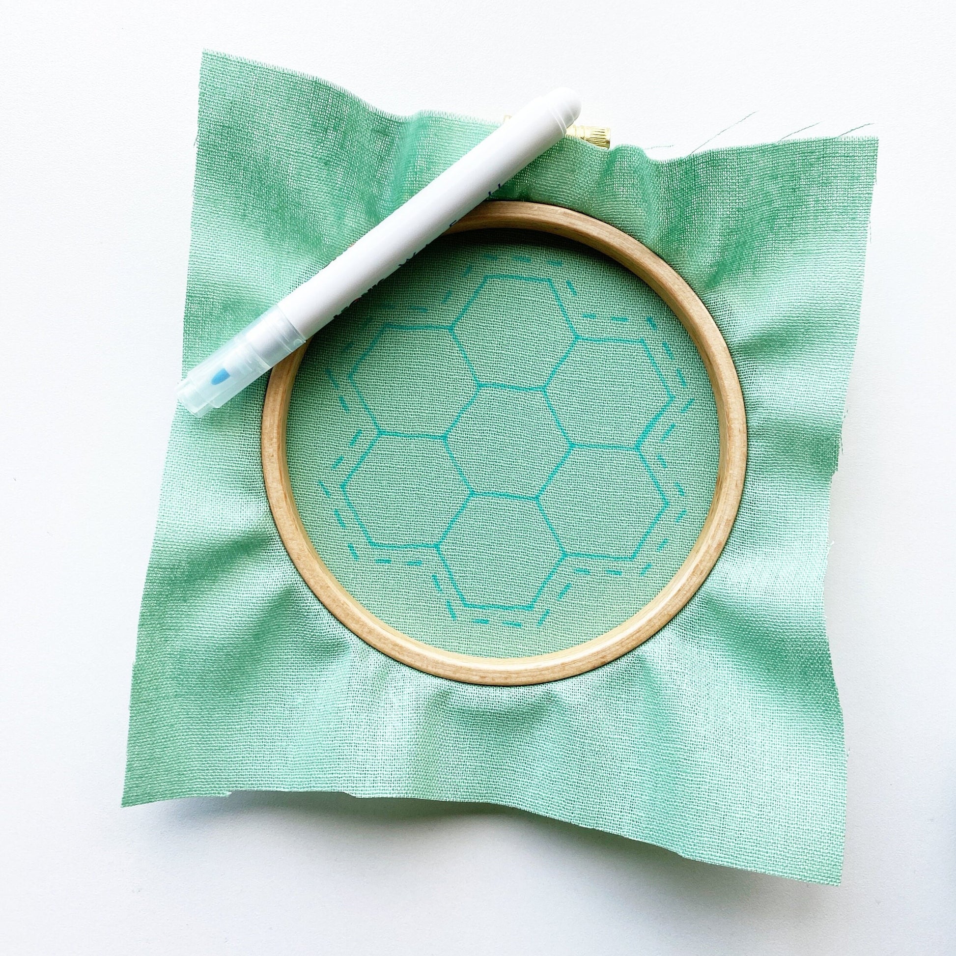 Rosanna Diggs Embroidery Hexie Harmony PDF.  Design features a modern take on the traditional paper pieced hexagon quilt pattern. Start by transferring your pattern using a sunny window and a water soluble marker.