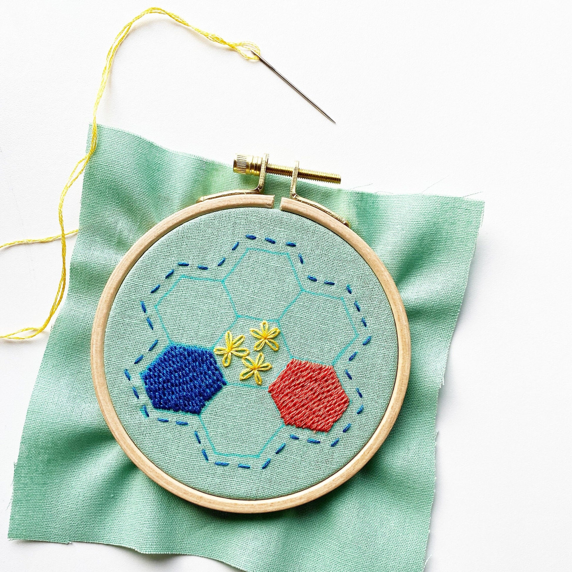 Rosanna Diggs Embroidery Hexie Harmony PDF.  Design features a modern take on the traditional paper pieced hexagon quilt pattern. Start by transferring your pattern using a sunny window and a water soluble marker.