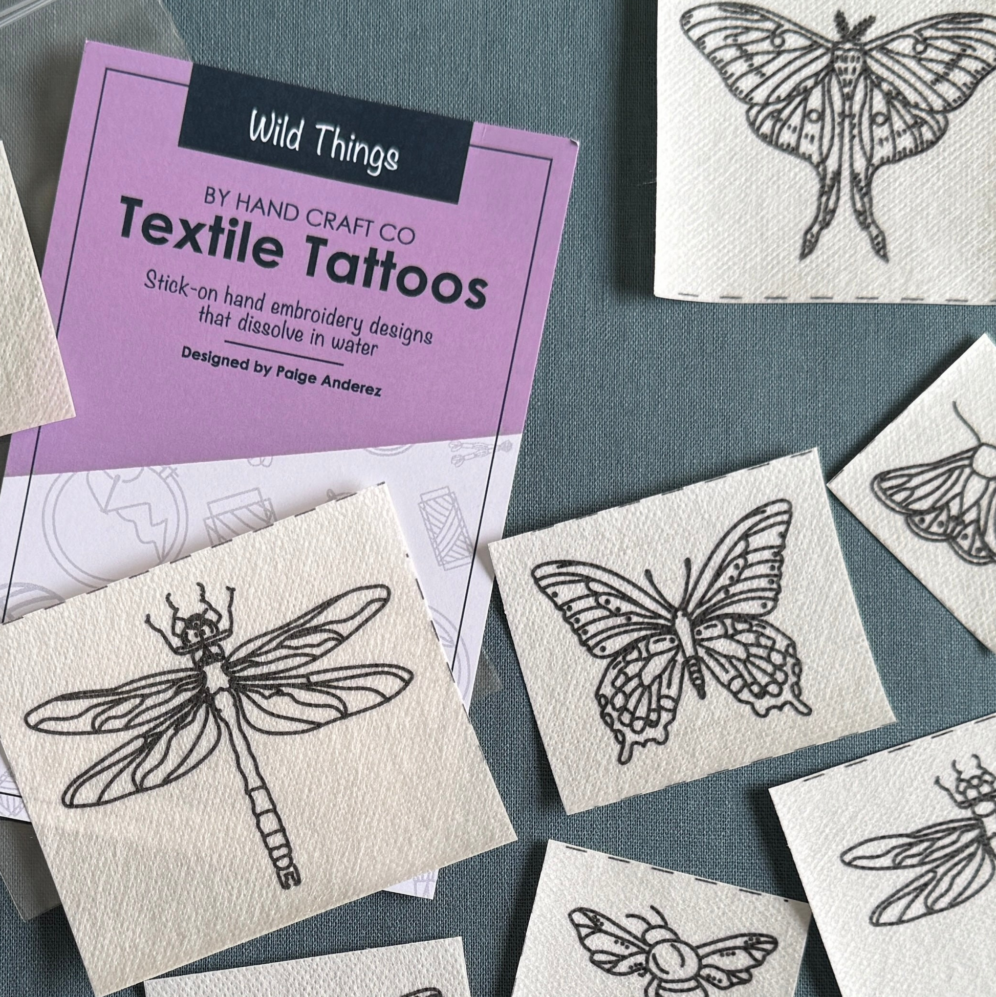 Textile tattoos with butterfly, dragonfly, and moth designs on a gray background.