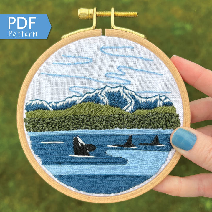 Orcas in the Sound Hand Embroidery PDF.  File includes pattern for transfer and booklet with easy to follow step by step instructions.  Part of the Pacific Wanderlust Collection.  Three Orcas swimming with Mountains in the background.