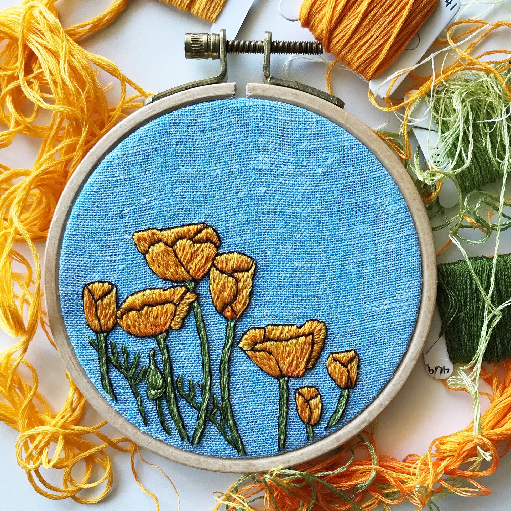 Peaceful Poppies Hand Embroidery PDF. PDF includes 10 pages of easy to follow directions that walk you through stitching seven poppies with detailed stems.