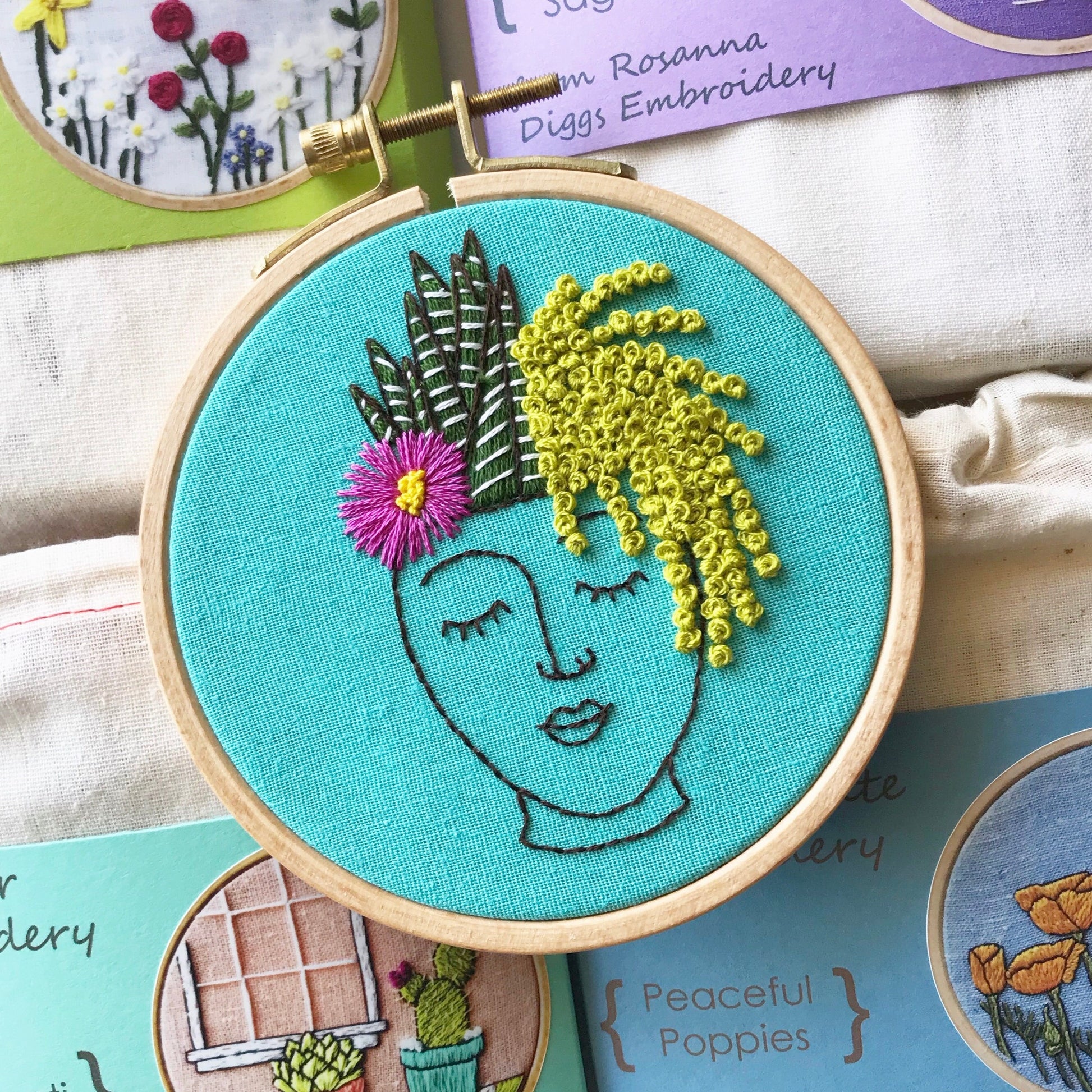 Zen Zoe PDF features a planter of a female face in black outline and has three different succulent plants cascading as her hair.  PDF includes pattern for transfer and 11 page booklet with easy to follow directions.