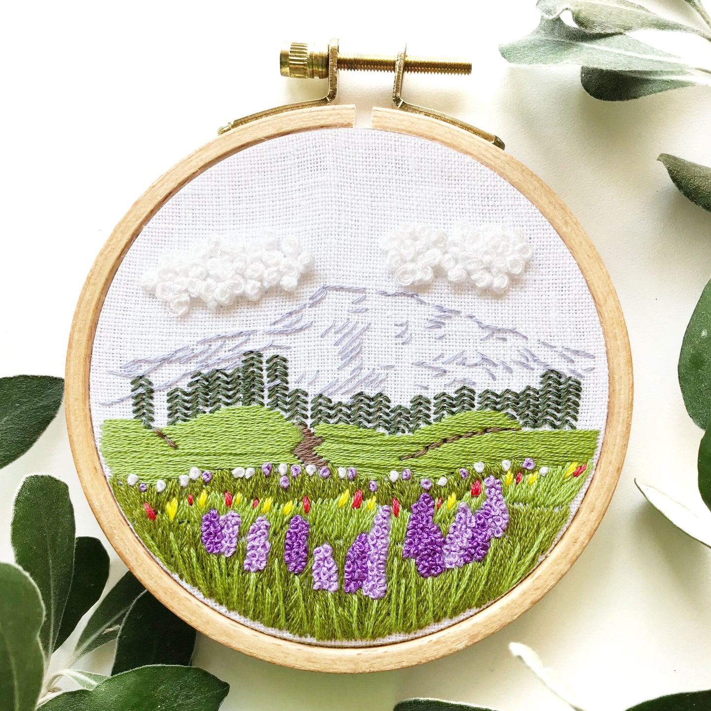 Mount Rainier Embroidery PDF.  Includes pattern for image transfer and 14 page booklet of easy to follow directions to complete.  Image has Mt Rainier in back with lupine and other small flowers in the foreground.