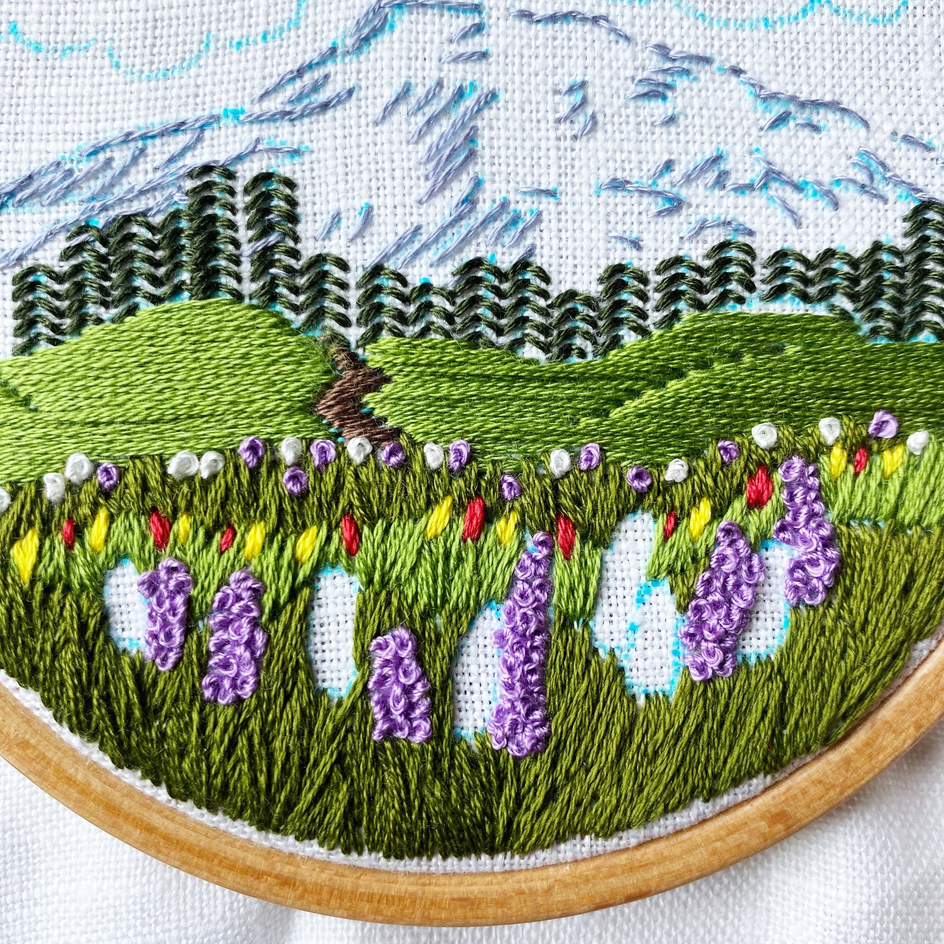 Mount Rainier Embroidery PDF.  Includes pattern for image transfer and 14 page booklet of easy to follow directions to complete.  Image has Mt Rainier in back with lupine and other small flowers in the foreground.