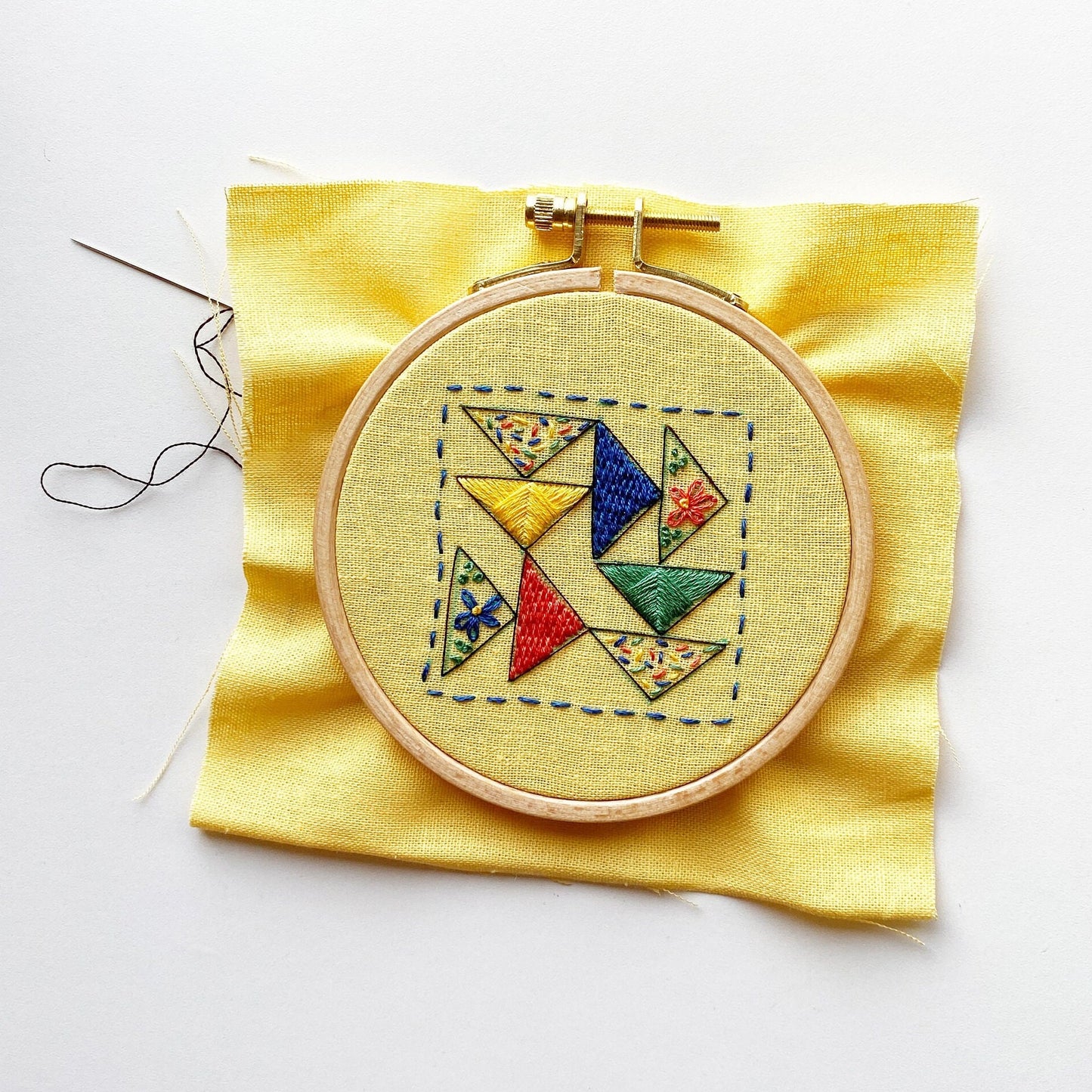 Rosanna Diggs Embroidery Triangle Tango PDF.  Design features a modern take on the traditional flying geese quit pattern.  Learn new stitches while making something beautiful. PDF includes pattern and 12 pages of easy to follow directions.